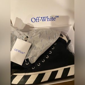 Men's OFF WHITE mid top vulcanized black canvas with white trim and details.
